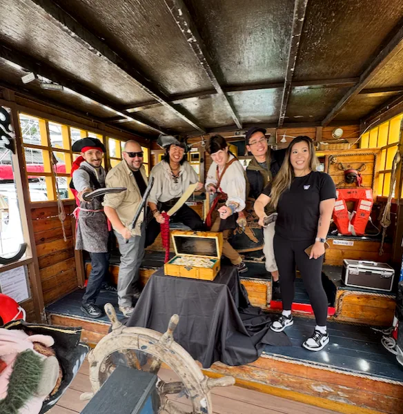 The Lost Treasure crew gathered aboard the pirate ship